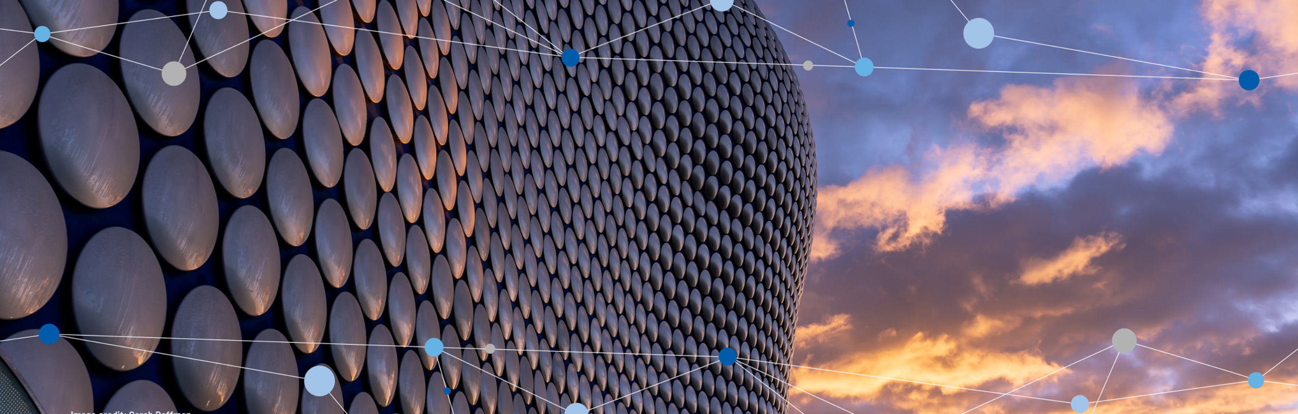 Birmingham Selfridge's building against a sunset sky with graphical elements over the top - Digis Squared sponsors UK 5G Showcase 2022